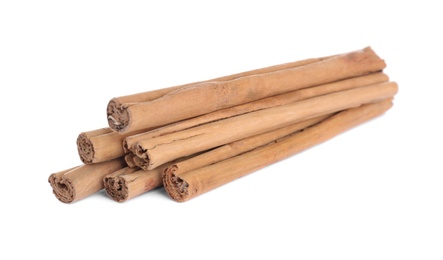 Photo of Aromatic brown cinnamon sticks on white background