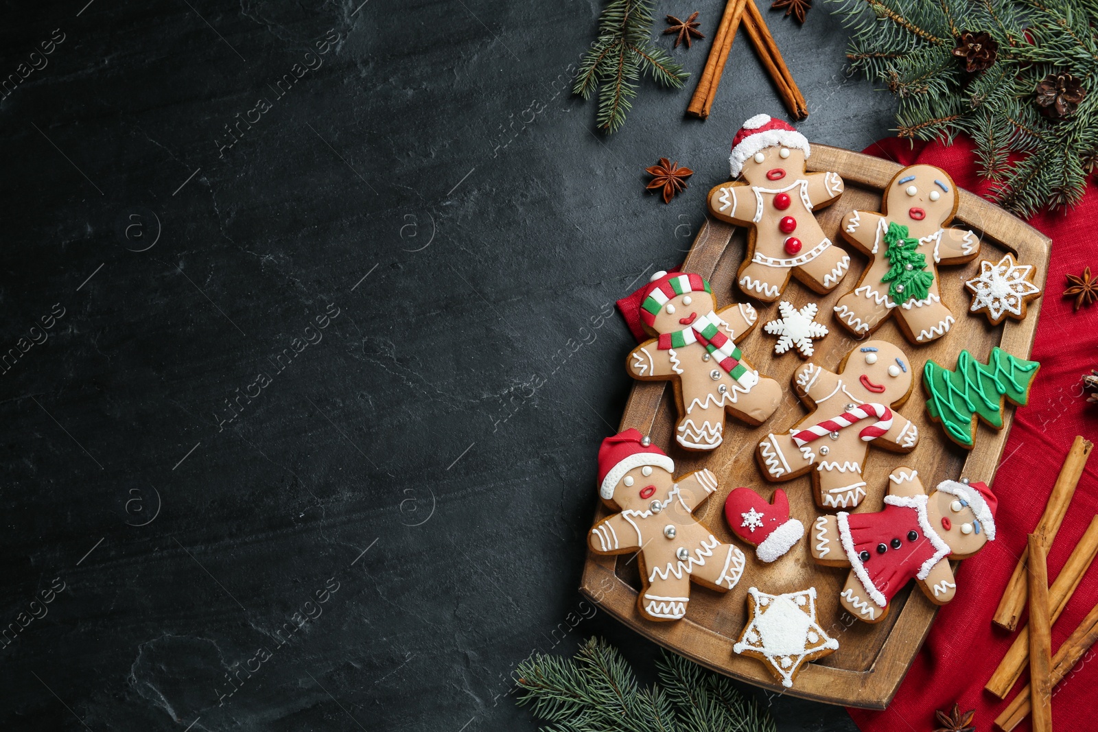 Photo of Flat lay composition with delicious Christmas cookies on black table, space for text