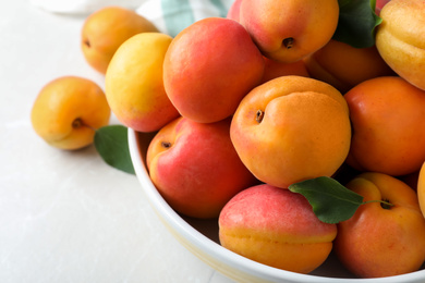 Photo of Delicious fresh ripe apricots on white table, closeup