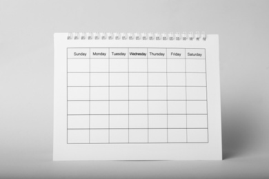 Photo of Blank paper calendar on grey background. Planning concept