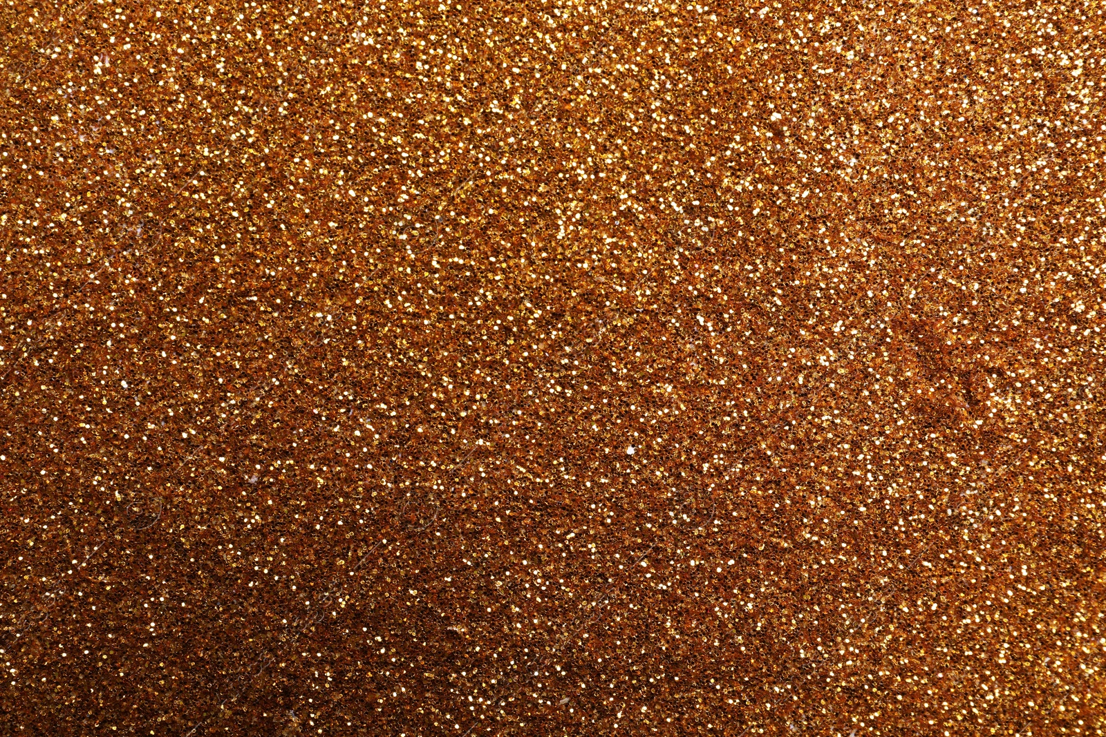 Photo of Beautiful shiny bronze glitter as background, closeup