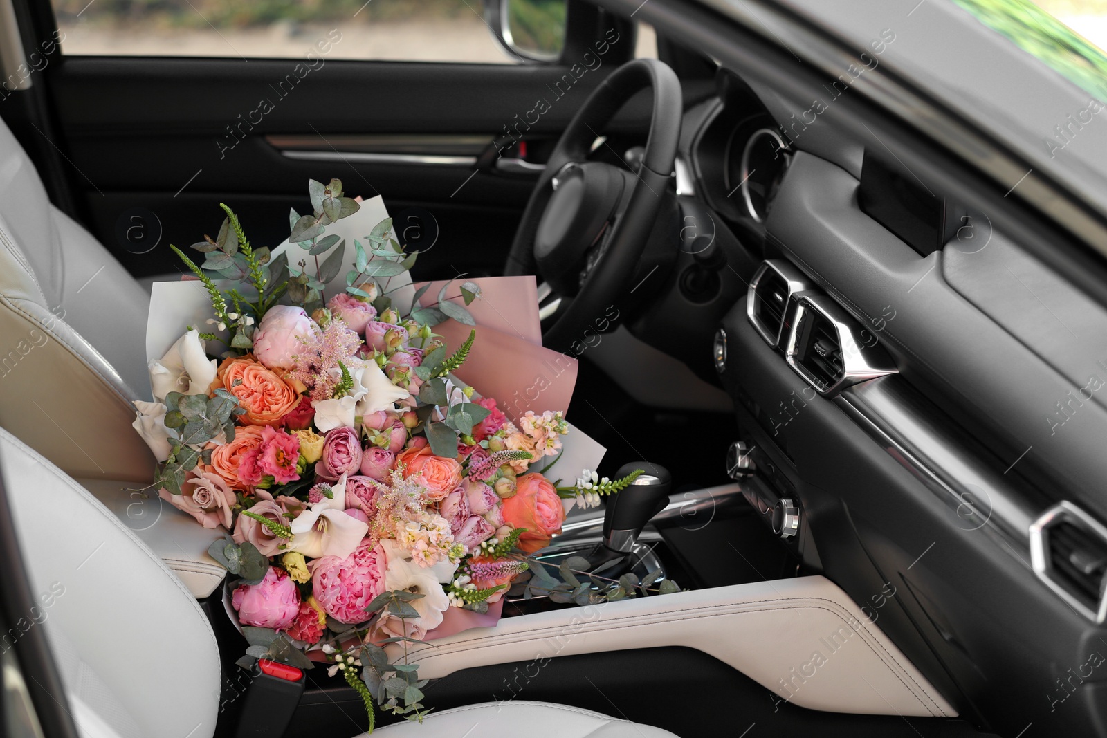 Photo of Beautiful flower bouquet inside car. Romantic surprise