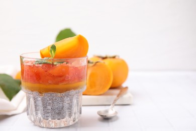 Photo of Delicious dessert with persimmon and chia seeds on table. Space for text