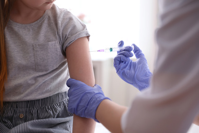 Little girl receiving chickenpox vaccination in clinic, closeup. Varicella virus prevention