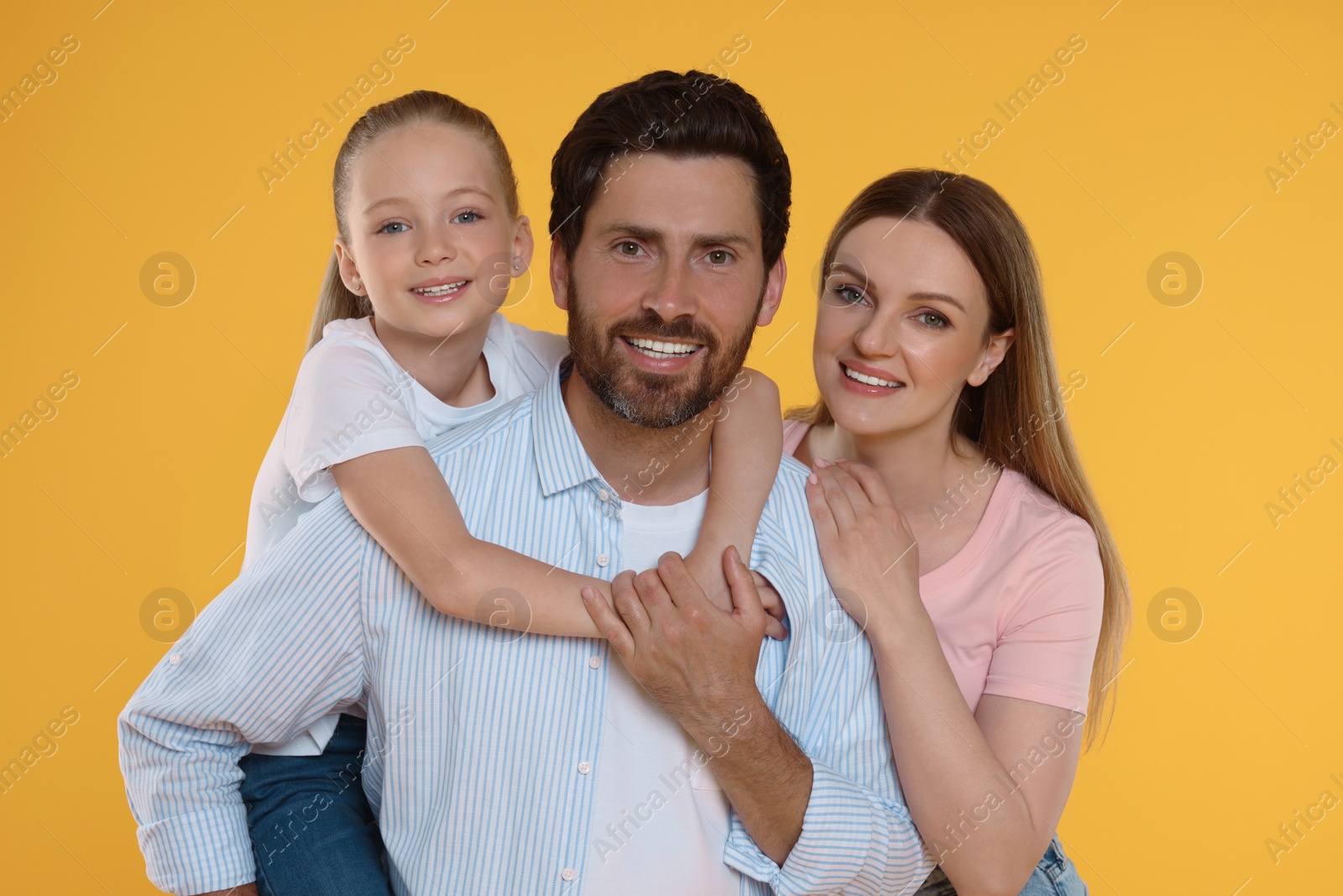 Photo of Portrait of happy family on orange background