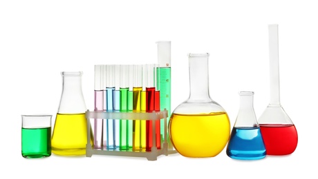 Photo of Laboratory glassware with colorful liquids on white background