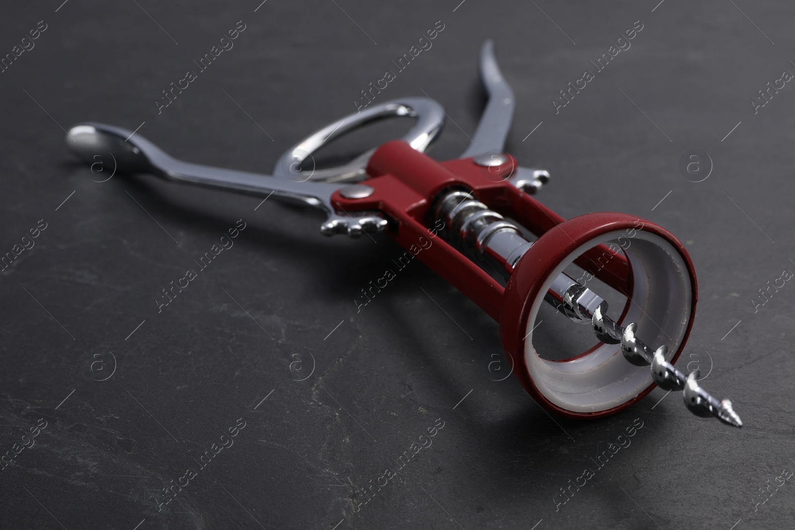 Photo of One wing corkscrew on grey textured table, closeup