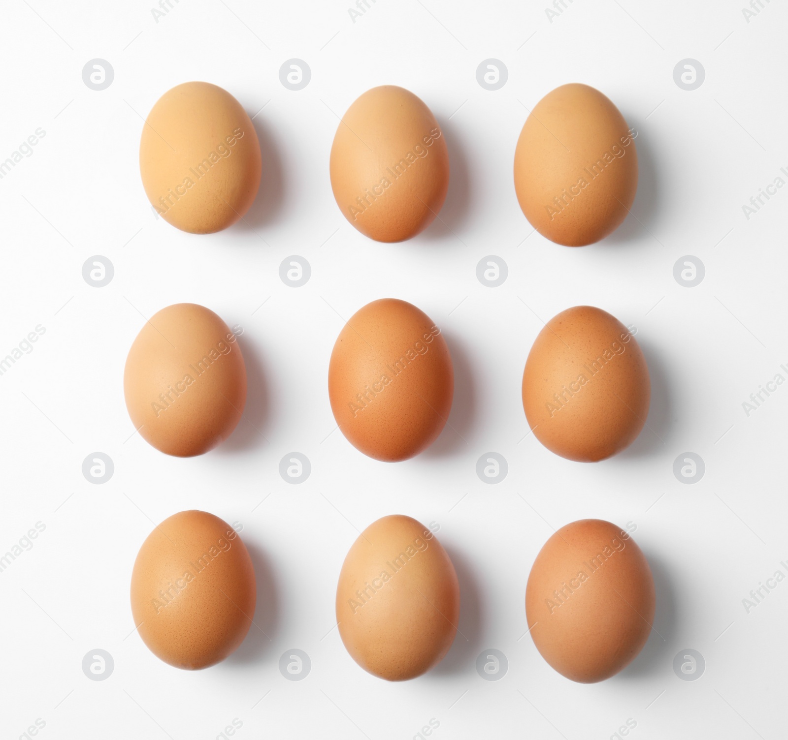 Photo of Raw chicken eggs on white background, top view