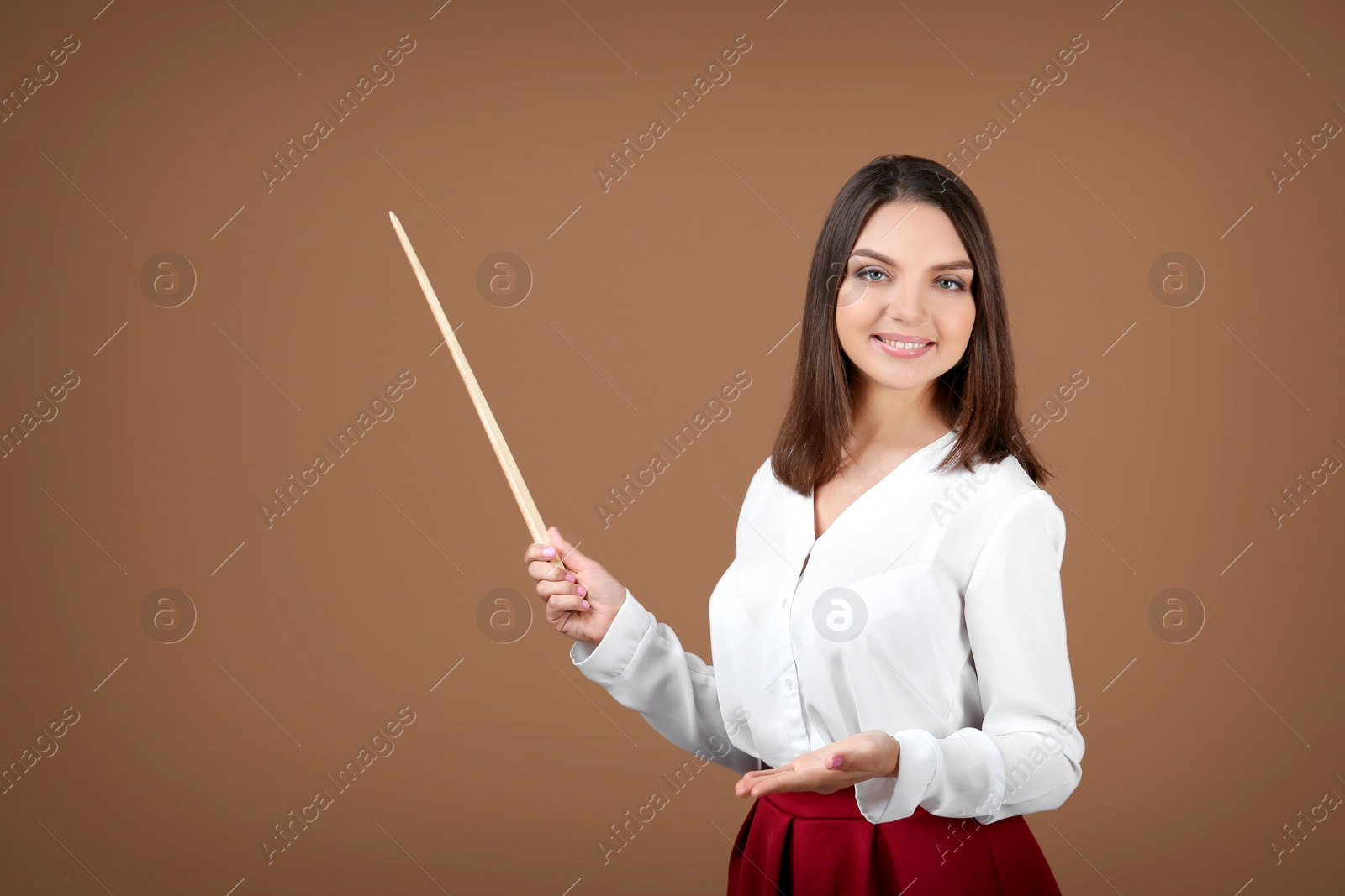 Photo of Portrait of female teacher with pointer on color background