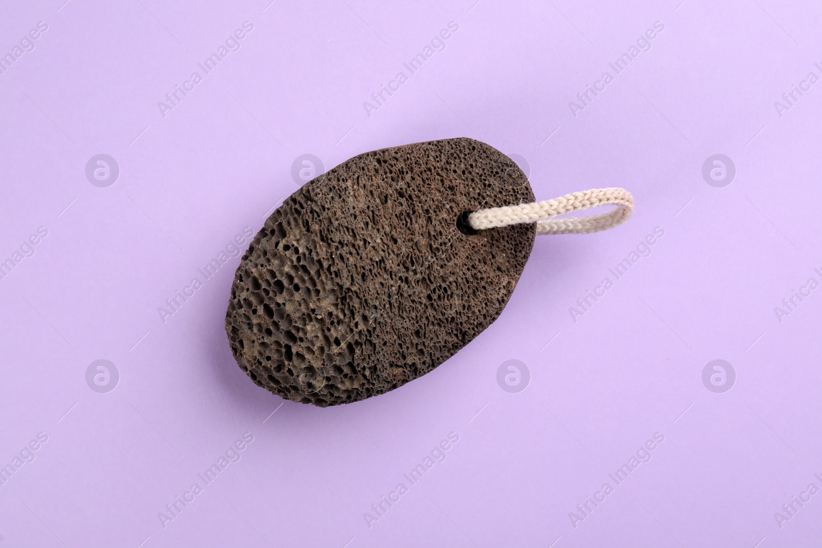 Photo of Pumice stone on violet background, top view