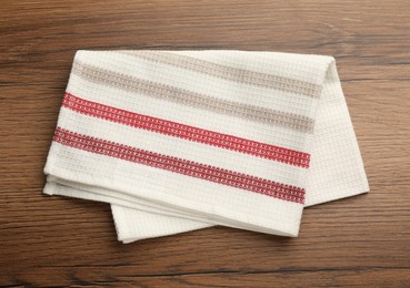 Striped kitchen towel on wooden table, top view