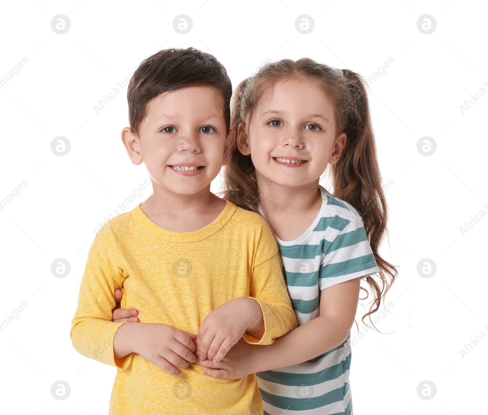 Photo of Cute little boy and girl hugging on white background