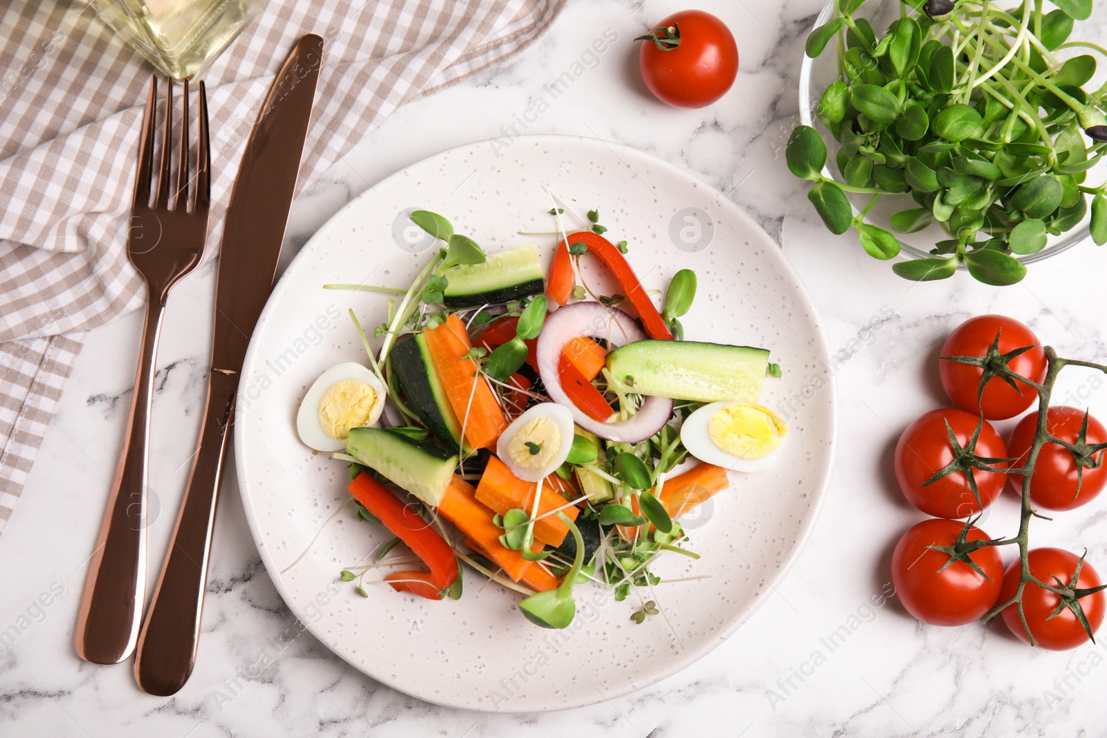 Photo of Salad with fresh organic microgreen in plate on white marble table, flat lay