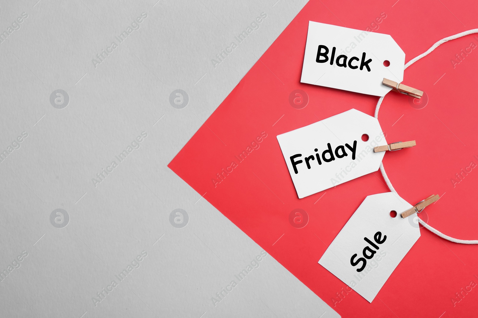 Photo of Blank tags on color background, flat lay with space for text. Black Friday concept