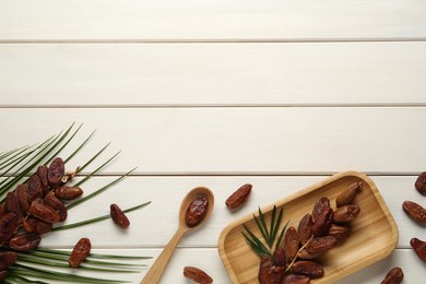 Photo of Flat lay composition with tasty sweet dried dates on white wooden table. Space for text