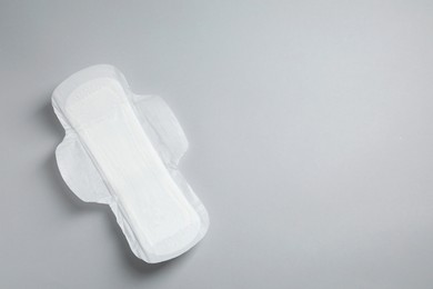 Sanitary napkin on light grey background, top view. Space for text