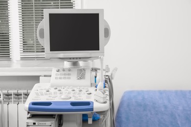 Photo of Ultrasound machine and examination table in hospital