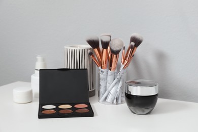 Photo of Stylish dressing table with different cosmetic products