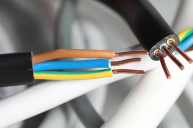 Photo of Colorful electrical wires on blurred background, closeup