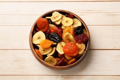 Photo of Mix of delicious dried fruits on white wooden table, top view