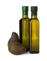 Photo of Vegetable fats. Bottles of cooking oils and fresh avocados isolated on white