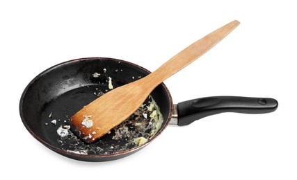 Photo of Dirty frying pan and wooden spatula on white background