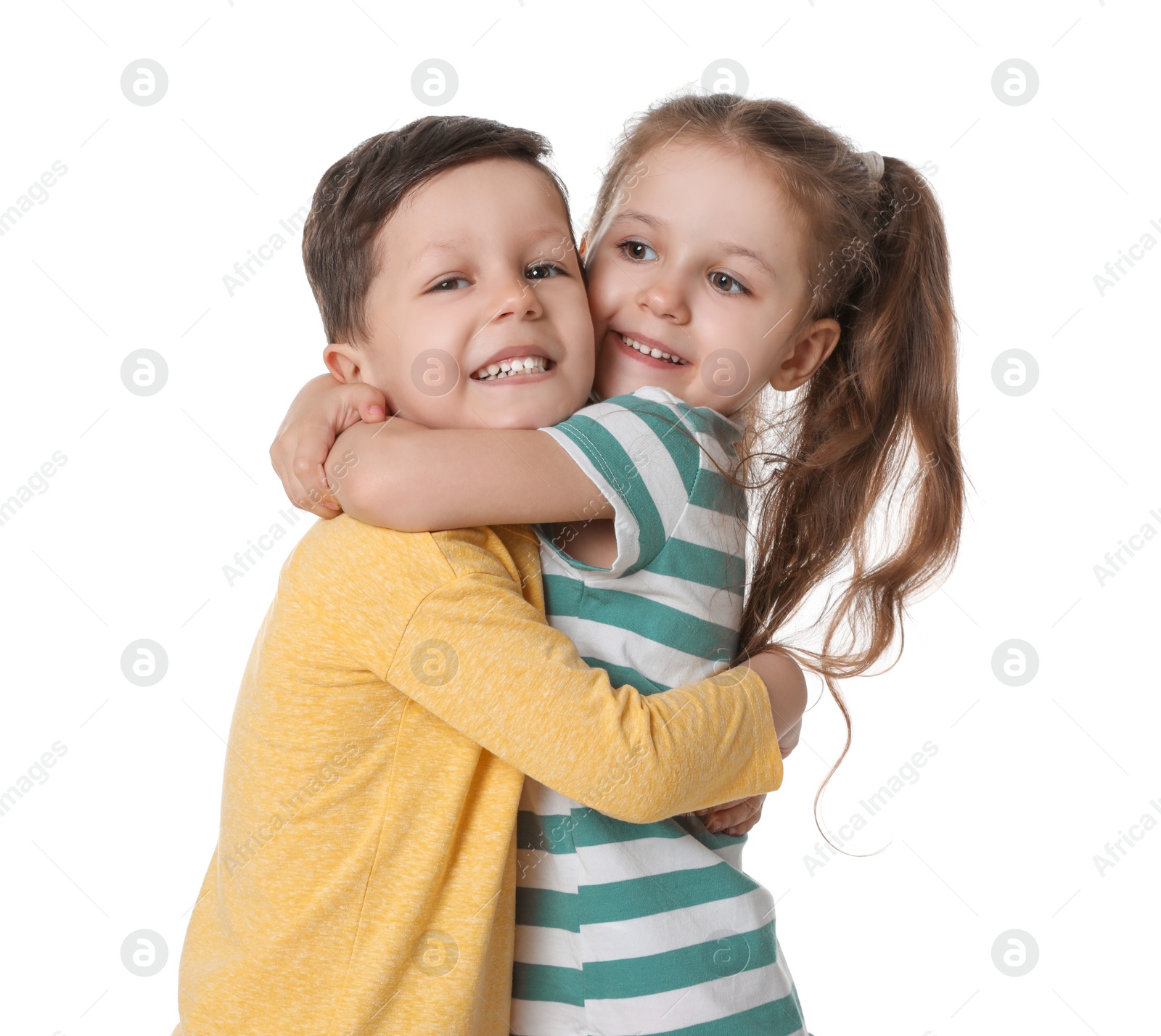 Photo of Cute little boy and girl hugging on white background