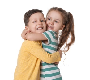 Photo of Cute little boy and girl hugging on white background