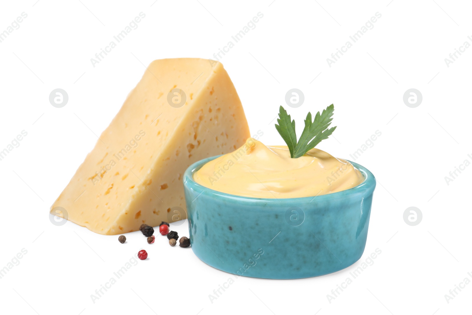 Photo of Tasty cheese, sauce with parsley and peppercorns on white background