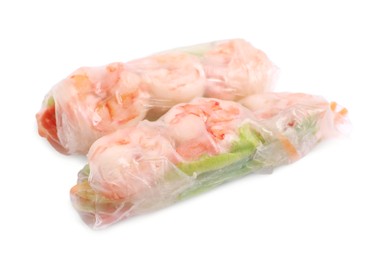 Tasty spring rolls with shrimps, carrot and lettuce on white background,