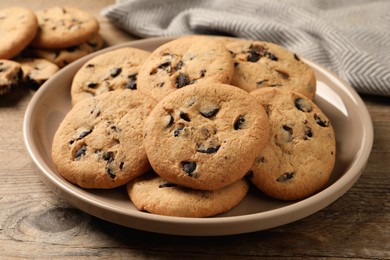 Delicious chocolate chip cookies on wooden table