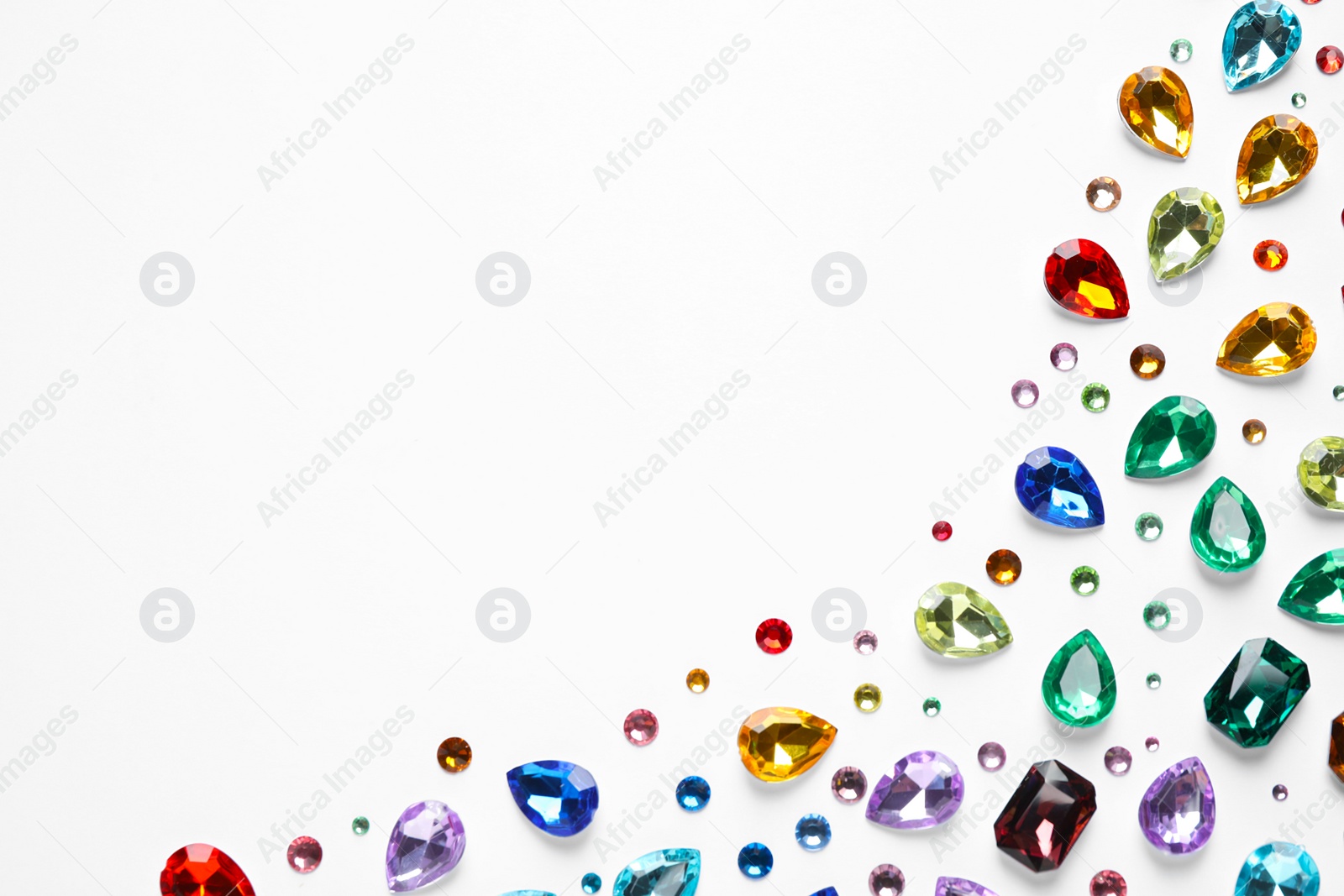 Photo of Different beautiful gemstones on white background, top view