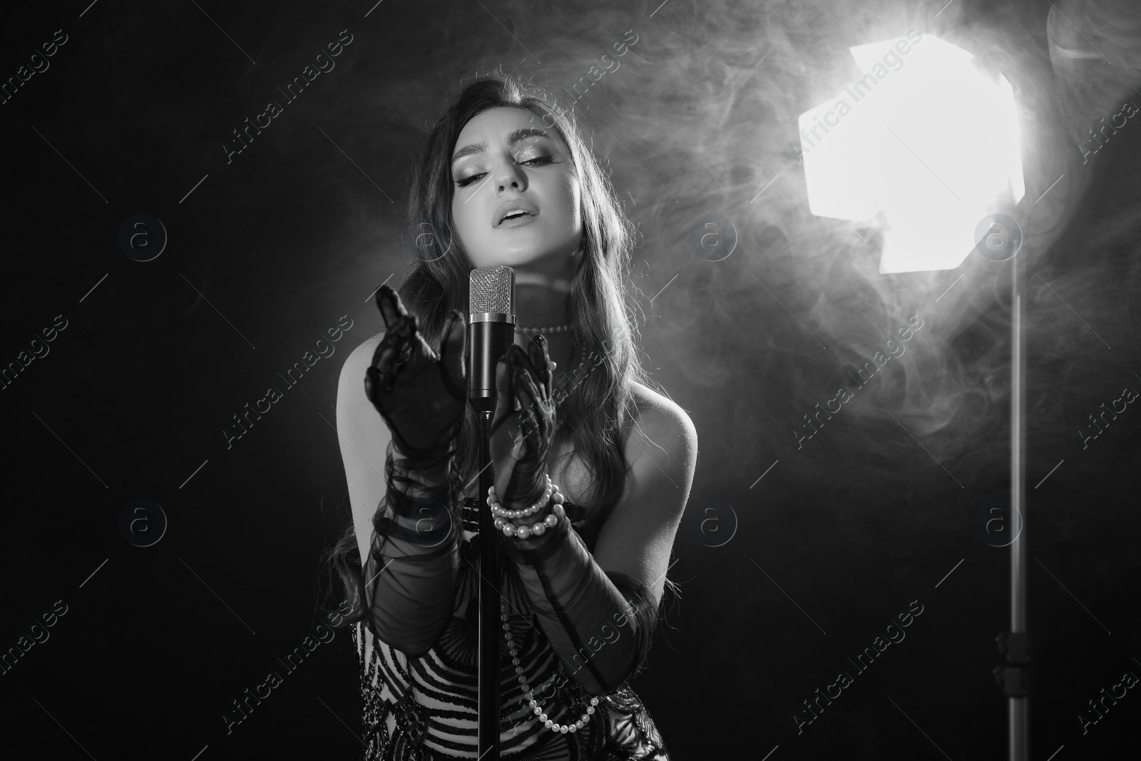 Image of Beautiful singer with microphone, black and white effect