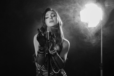 Image of Beautiful singer with microphone, black and white effect