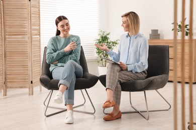 Photo of Professional psychotherapist working with patient in office