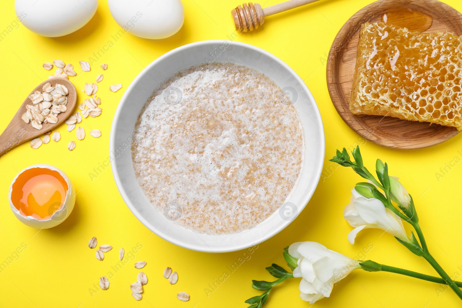 Photo of Homemade hair mask and ingredients on yellow background, flat lay