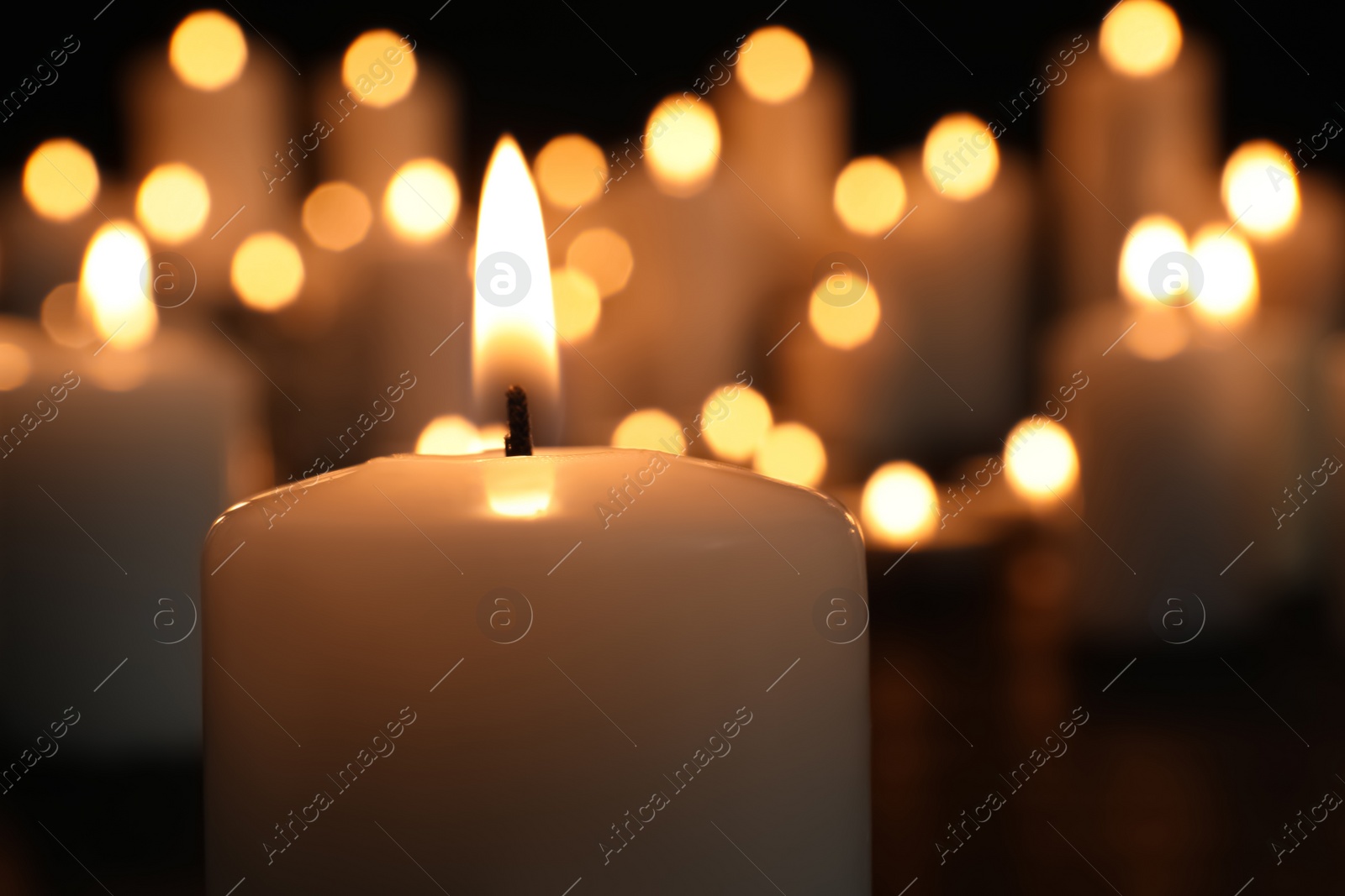 Photo of Burning candle in darkness, closeup. Memory day