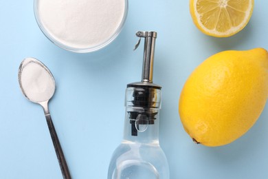 Photo of Eco friendly natural cleaners. Vinegar in bottle, soda and lemons on light blue background, flat lay