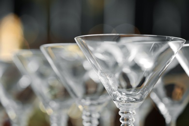 Photo of Empty martini glasses on blurred background, closeup