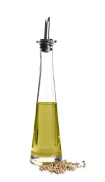 Bottle with hemp oil and seeds on white background