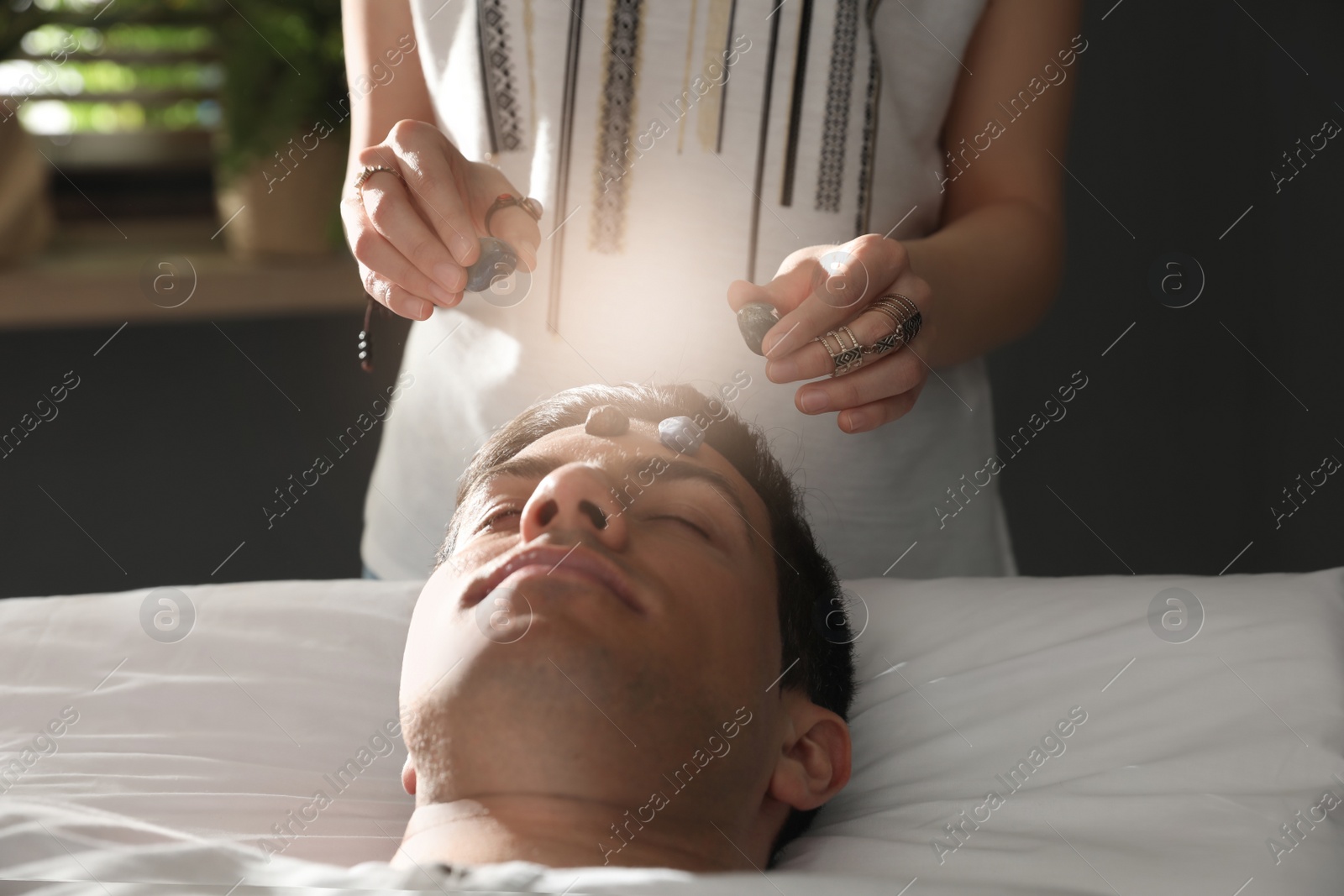 Photo of Man during crystal healing session in therapy room