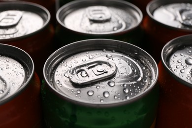 Photo of Energy drink in wet cans, closeup. Functional beverage