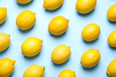 Photo of Many fresh ripe lemons on light blue background, flat lay