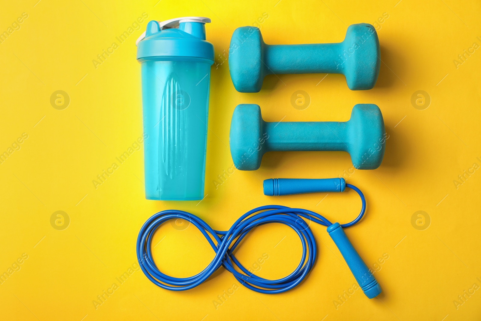 Photo of Flat lay composition with jump rope on color background