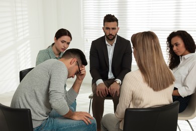 Psychotherapist working with patients at group session indoors