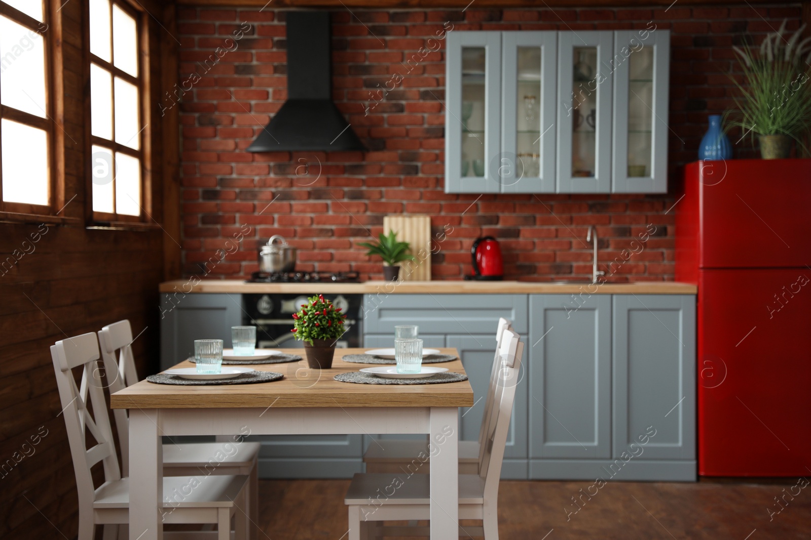 Photo of Stylish kitchen interior with dining table and chairs