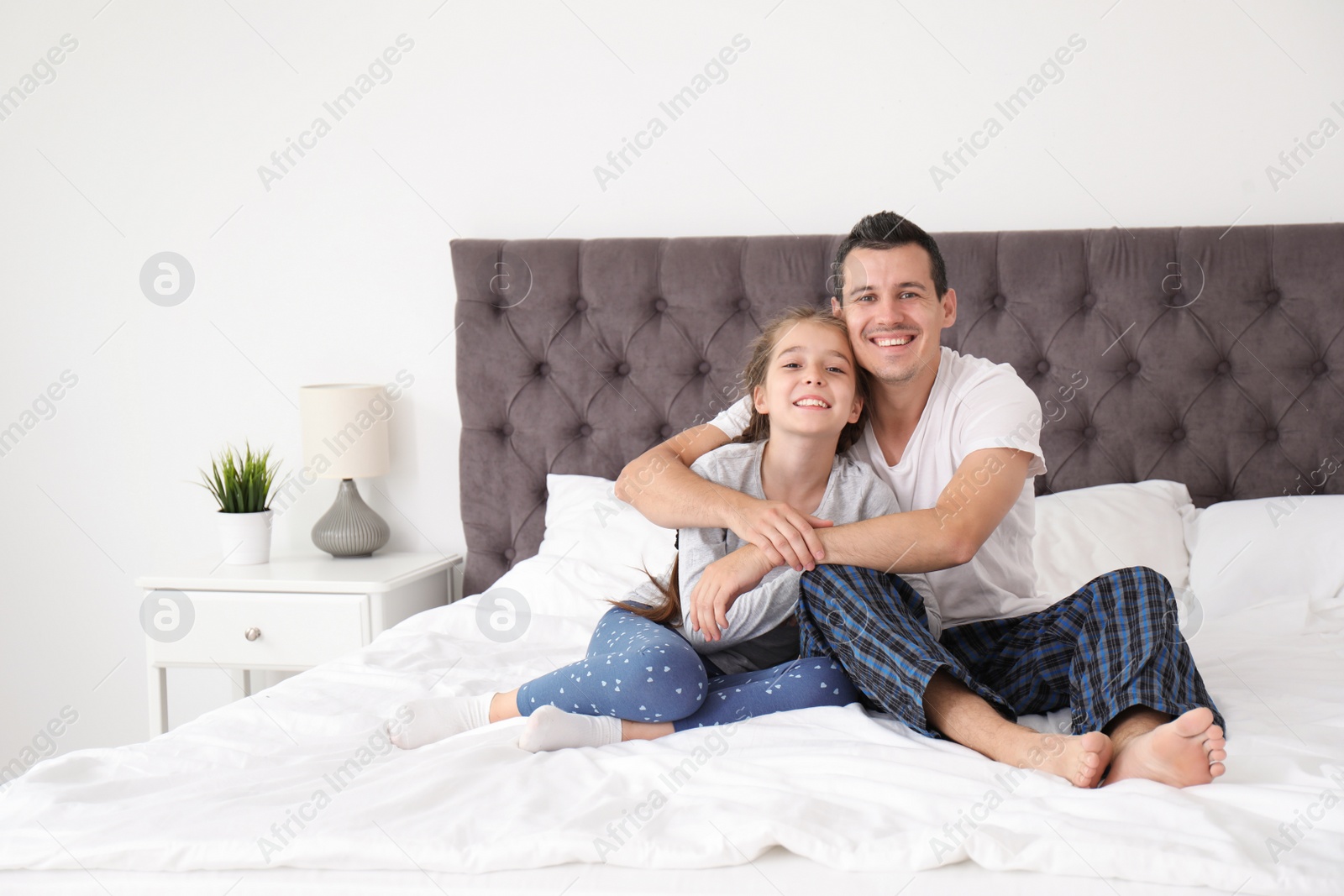 Photo of Father with his cute child in bedroom. Happy family