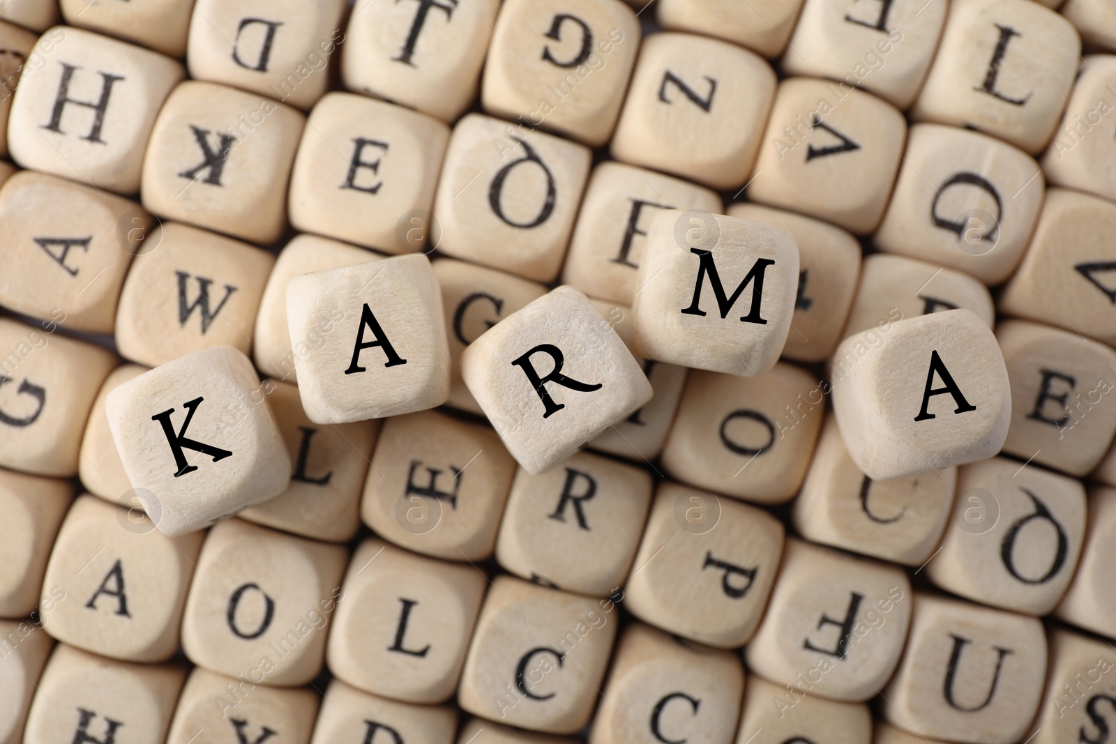 Photo of Many cubes with letters and some of them making word Karma, top view