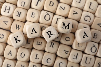 Photo of Many cubes with letters and some of them making word Karma, top view