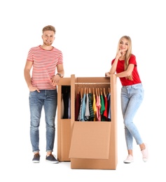 Photo of Young couple near wardrobe boxes on white background